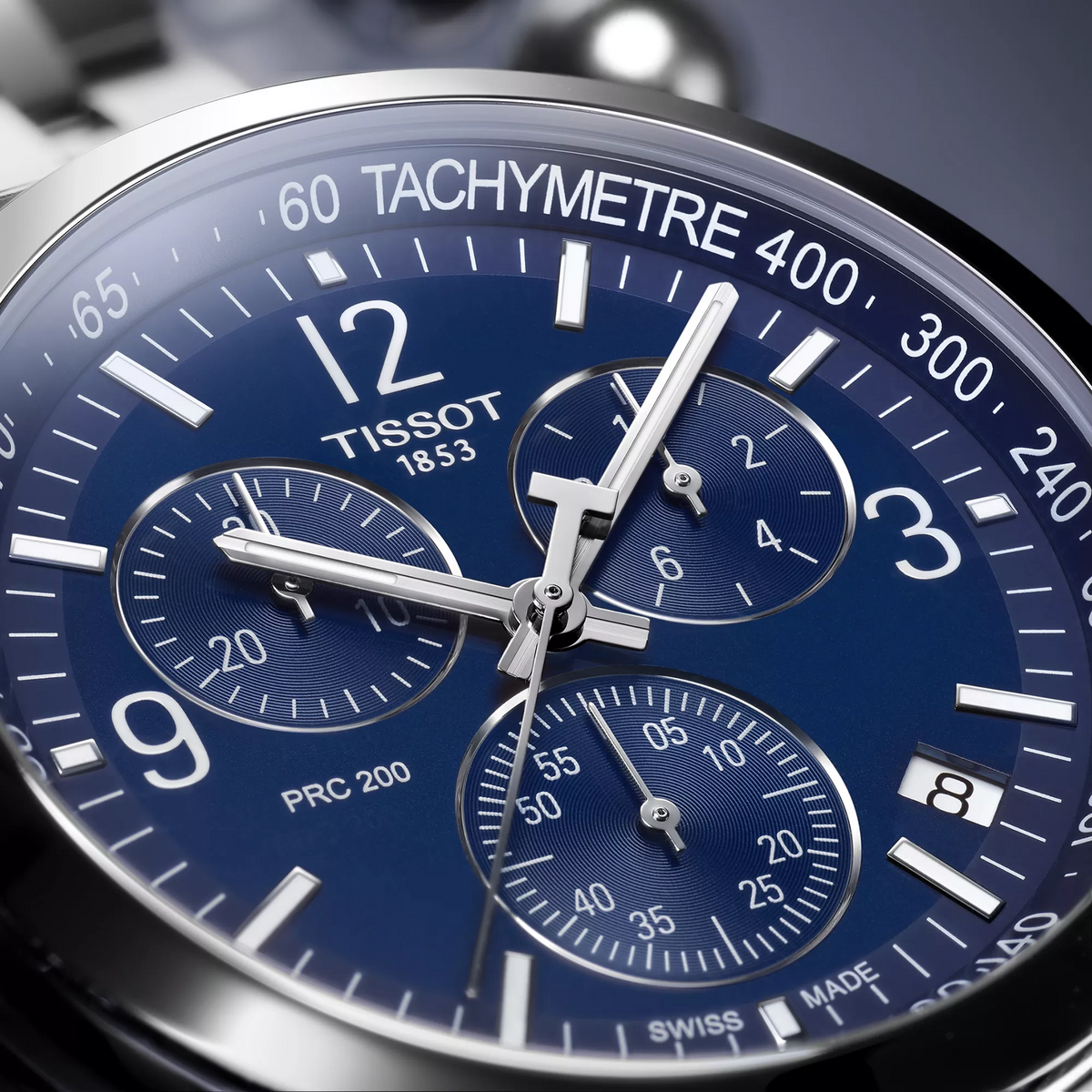 Tissot PRC 200 43mm watch on a colored background