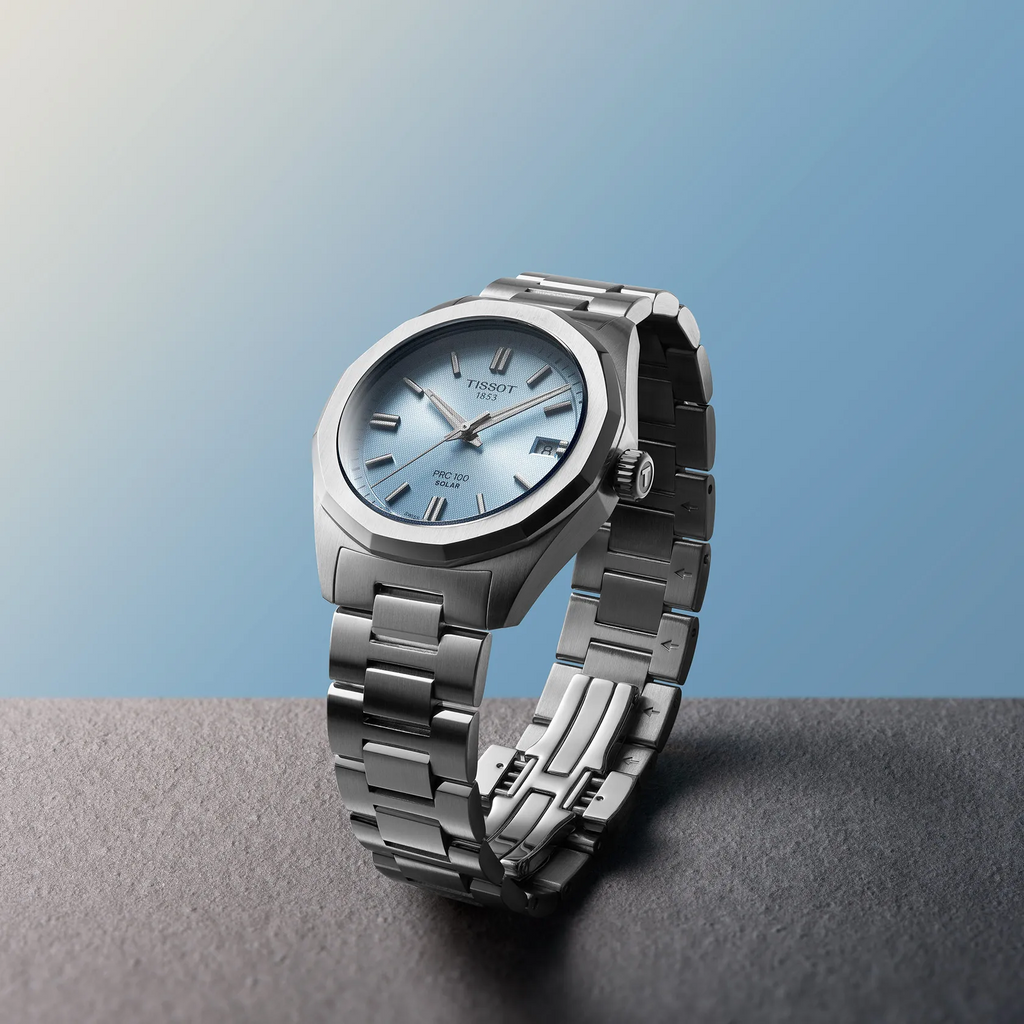 Tissot PRC 100 Solar 34mm watch on a colored background