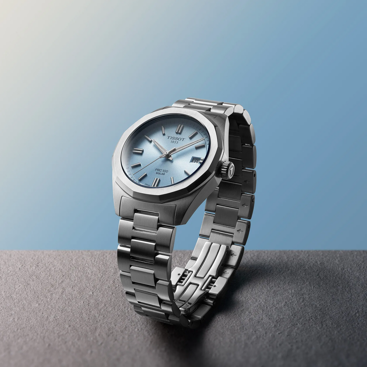 Tissot PRC 100 Solar 34mm watch on a colored background