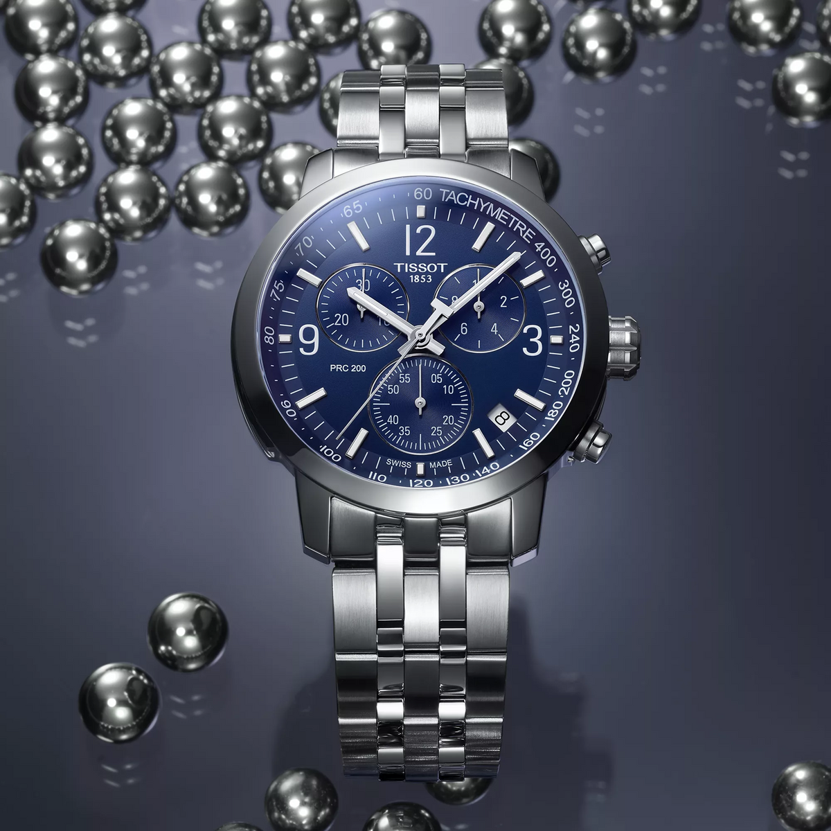 Tissot PRC 200 43mm watch on a colored background